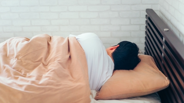 全盲になった当事者がベッドで眠り、睡眠中に見る夢について考察するイメージ